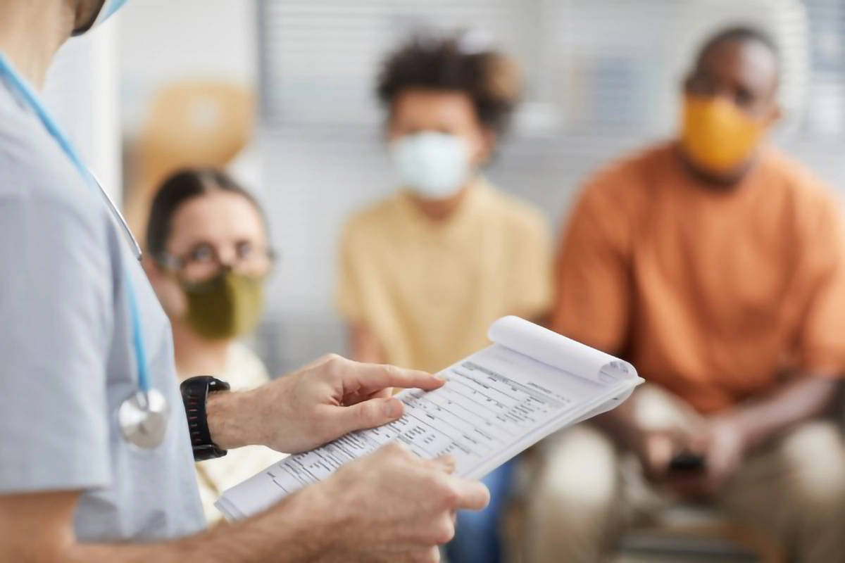 Image of a clinical staff member calling out patient names