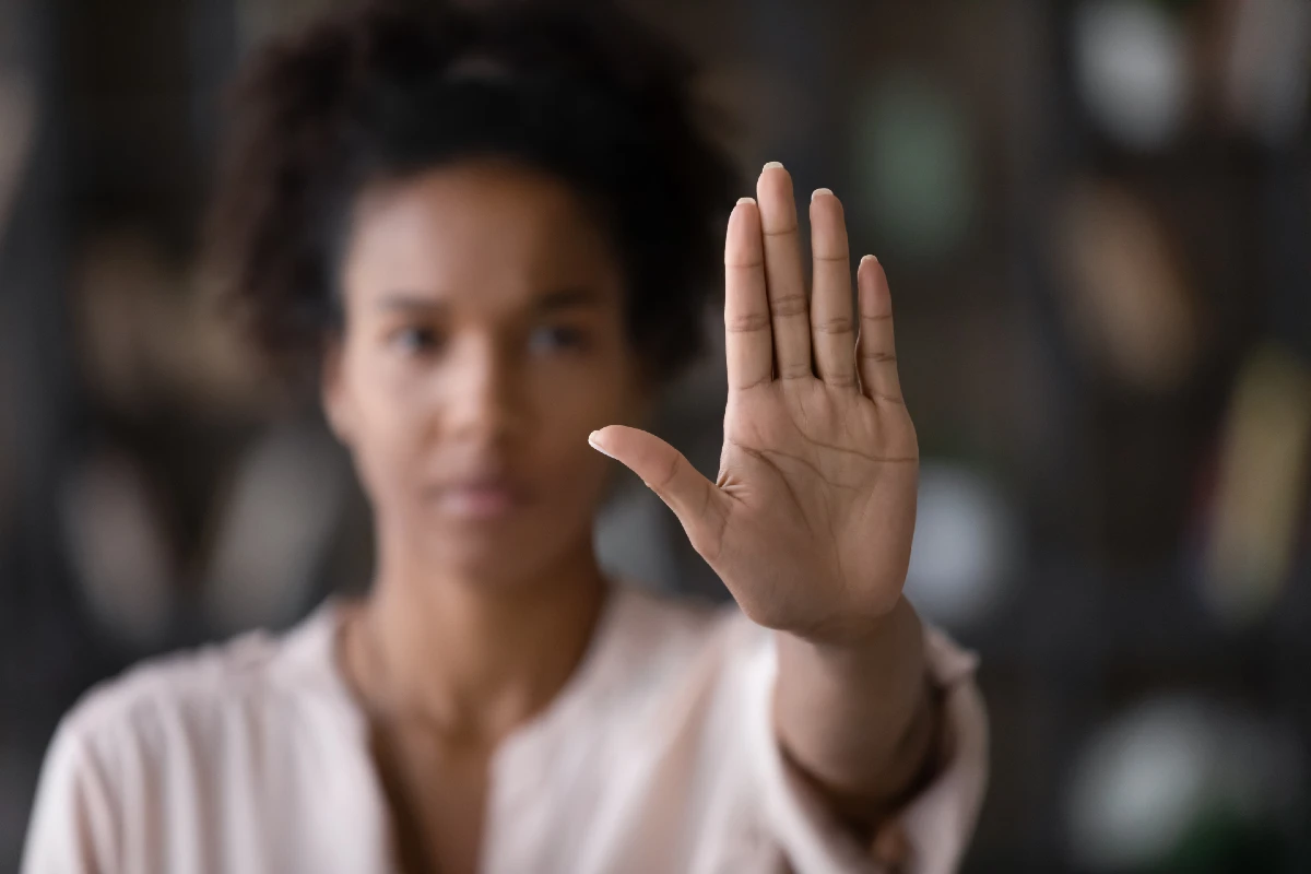 Image of a woman holding her hand in a stop motion